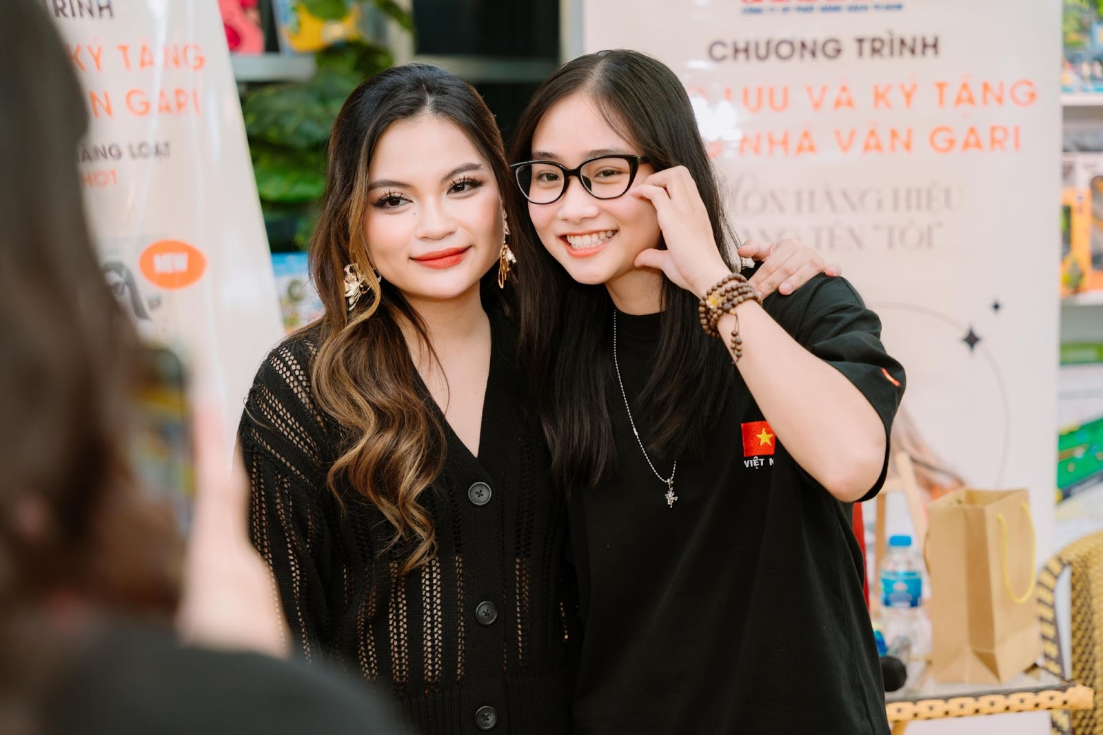 Two women posing for a pictureAI-generated content may be incorrect.