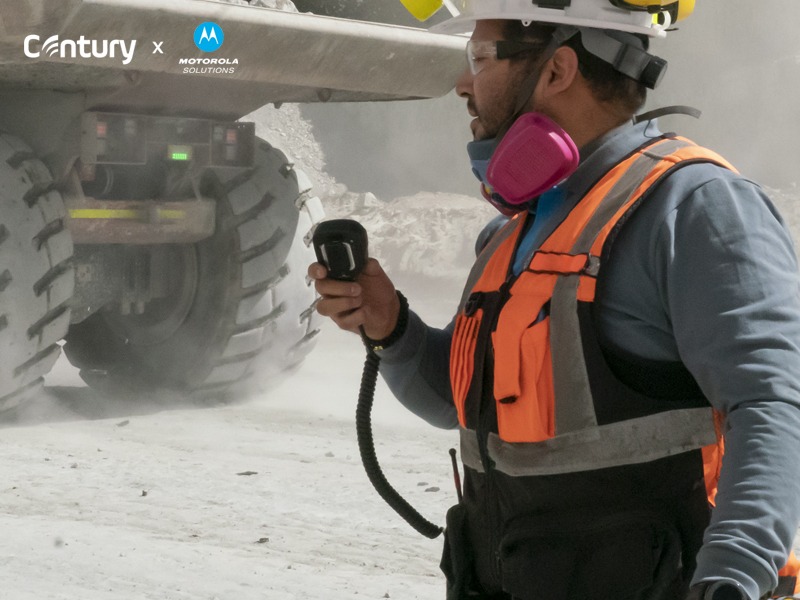 A person in a safety vest holding a radioAI-generated content may be incorrect.